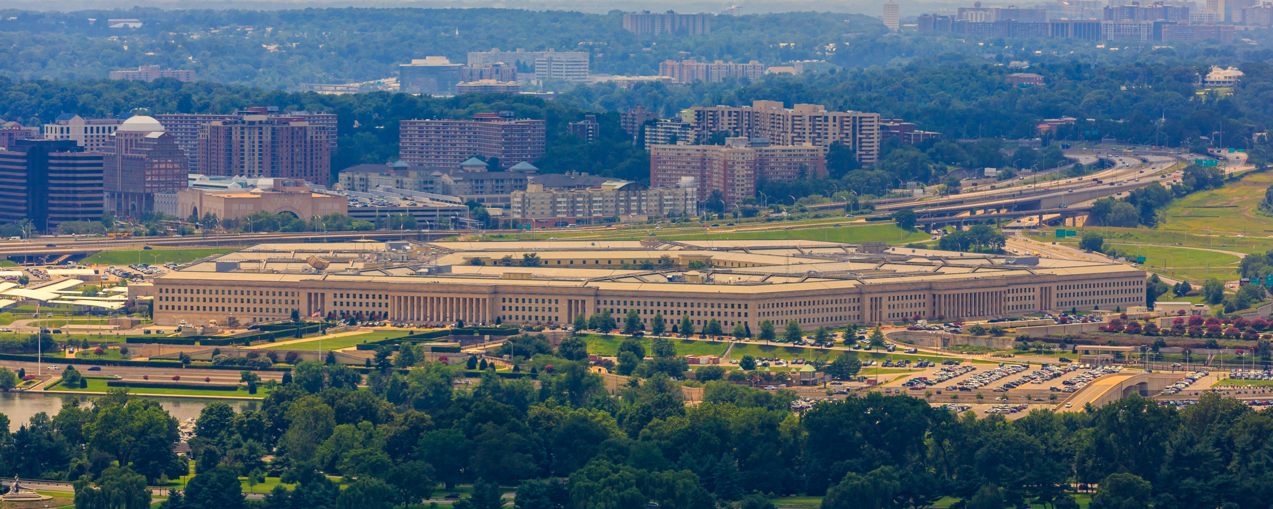 Aerial view of the Pentagon surrounded by trees and buildings in Arlington, Virginia.