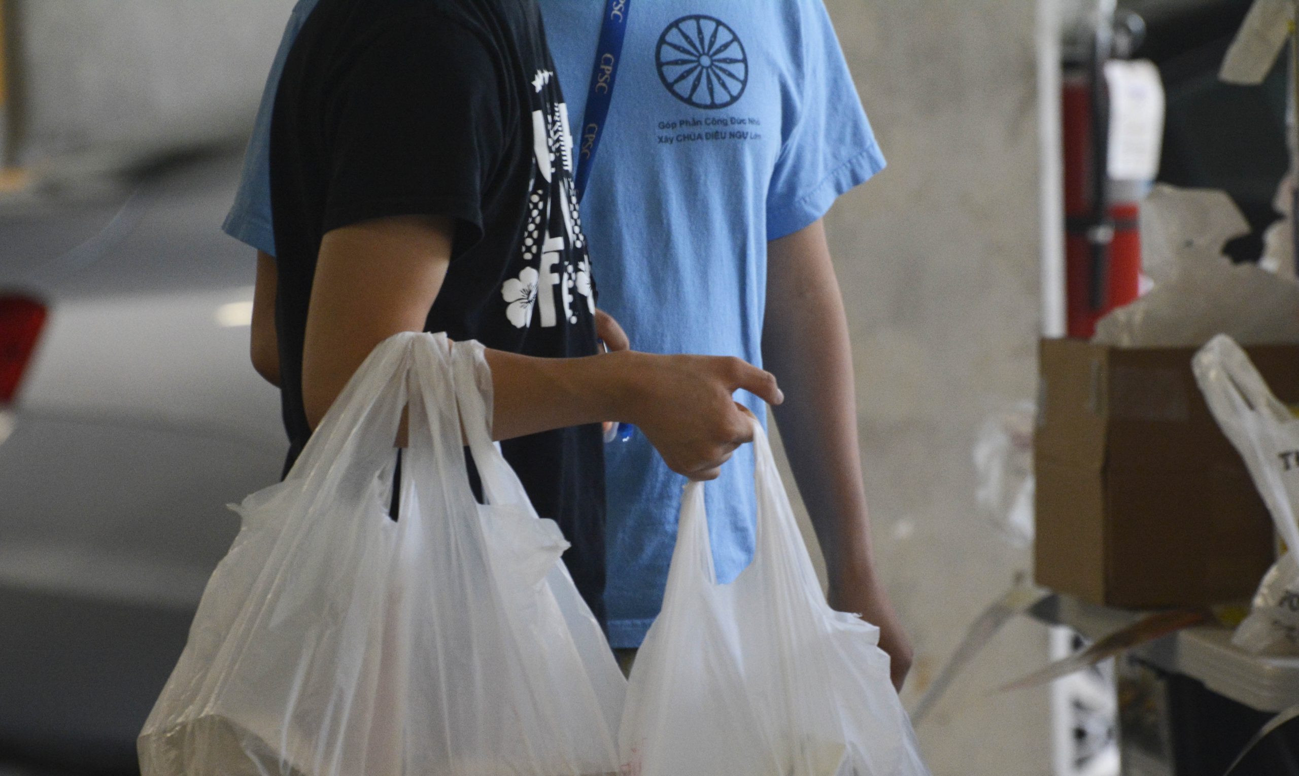 Residents in the parking garage of Gilliam Place pick up donations during COVID