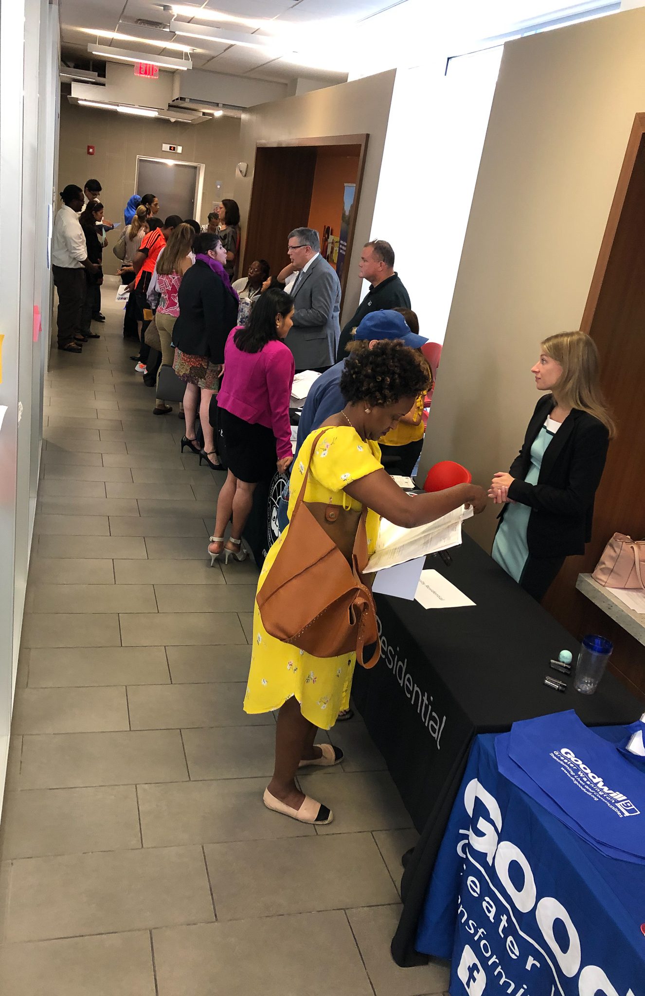 Job seekers attending a career fair hosted by various organizations.