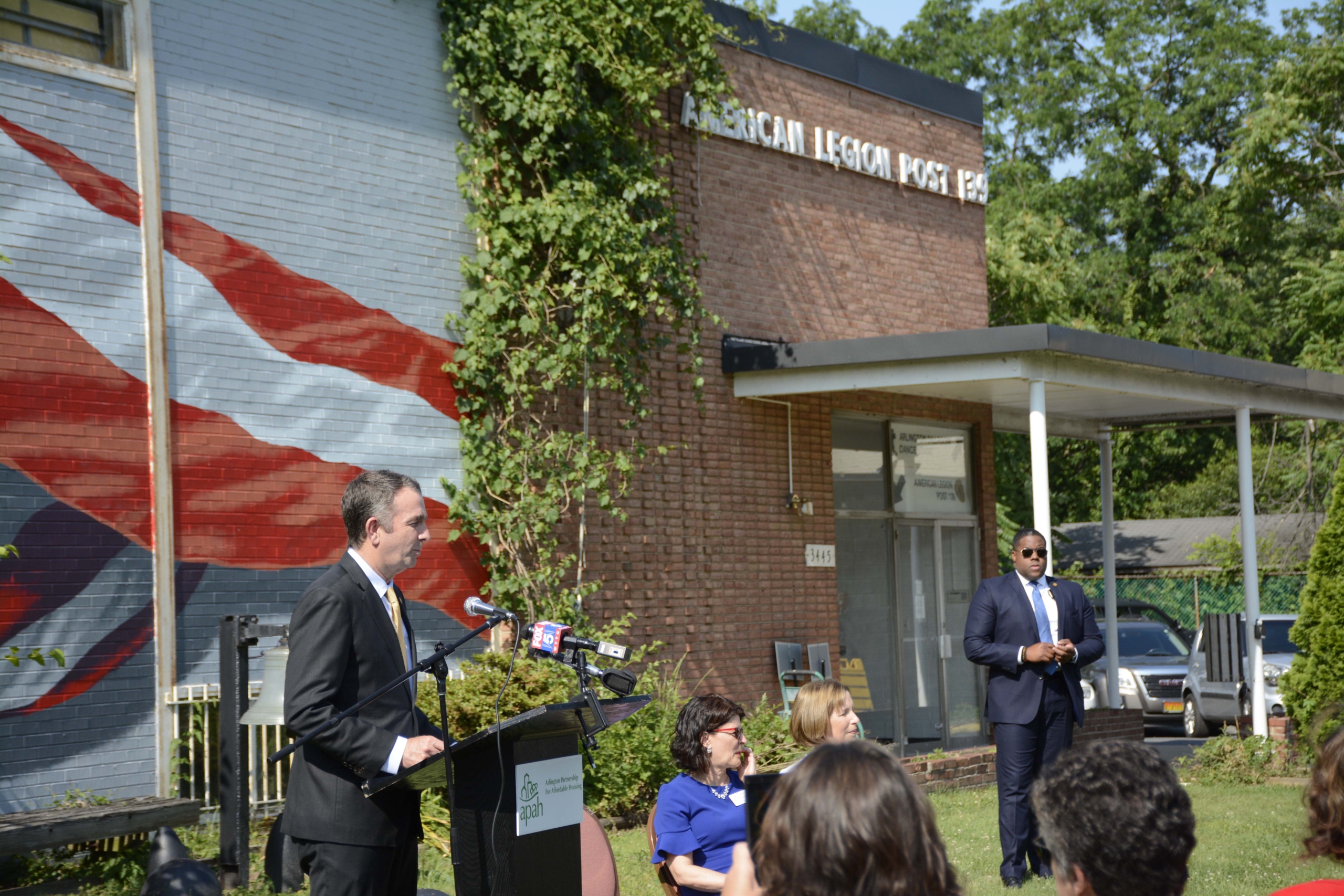 Governor giving a speech in front of the American Legion Post 139.