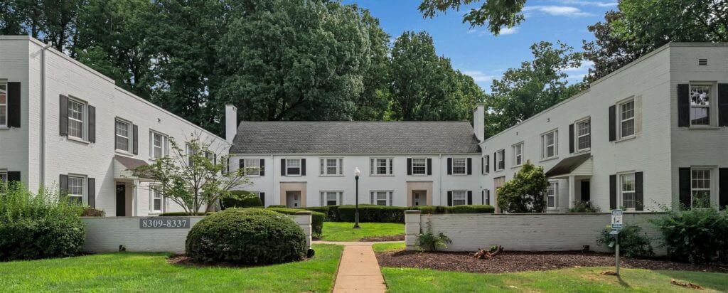 Two-story gray house, with a garden in the center.