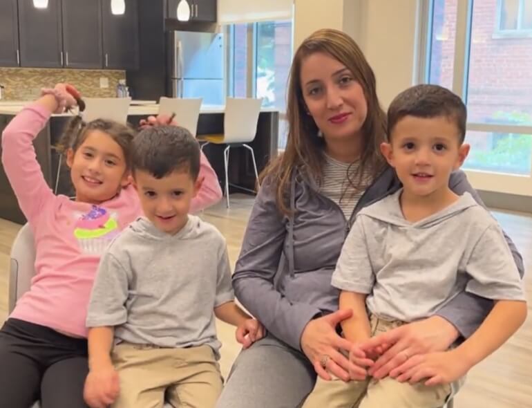 Mother with three children in a cozy kitchen