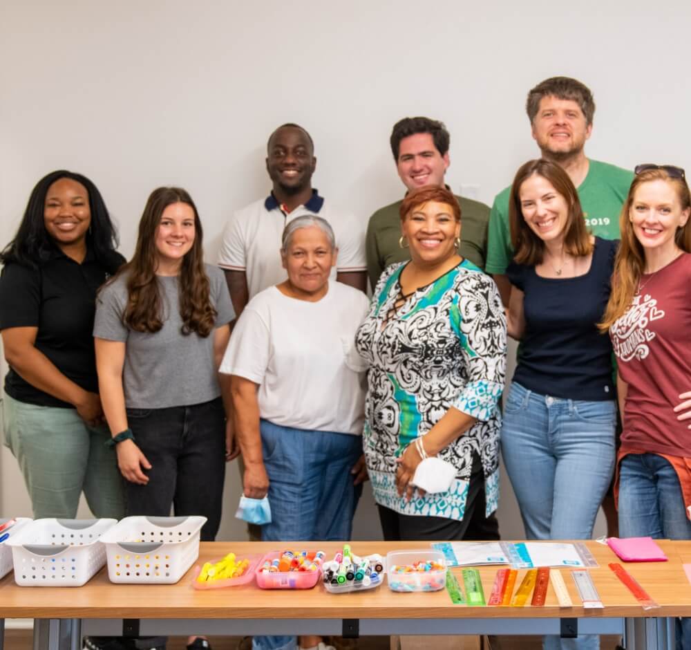 Group of volunteers posing with crafting supplies