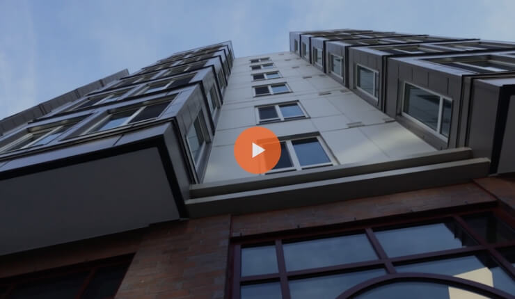 Screenshot of a video where you can see a building from below.