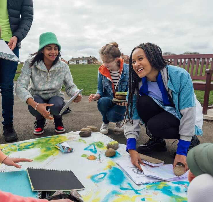 Group of young people engaged in an outdoor creative activity